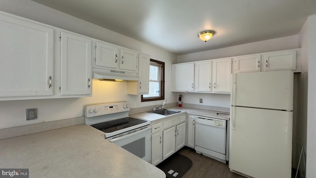 kitchen with sink, white cabinets, dark hardwood / wood-style floors, and white appliances