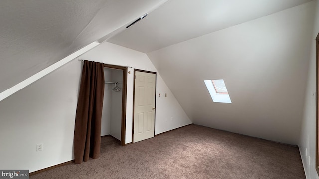 bonus room featuring lofted ceiling with skylight and carpet floors