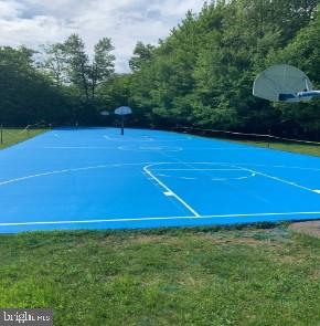 view of basketball court featuring a lawn