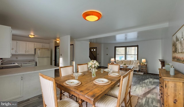 dining space with dark hardwood / wood-style flooring and sink