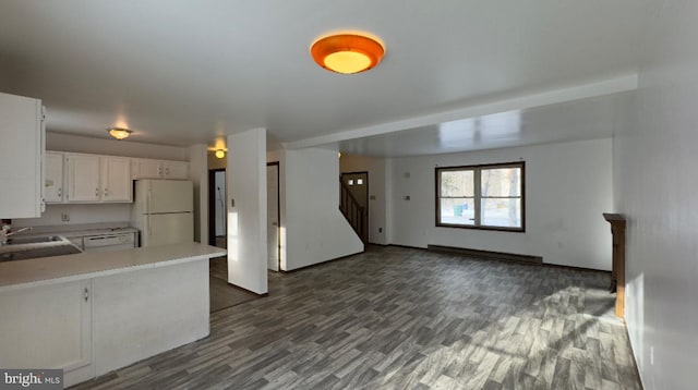 kitchen featuring kitchen peninsula, a baseboard heating unit, white refrigerator, white cabinets, and dark hardwood / wood-style floors