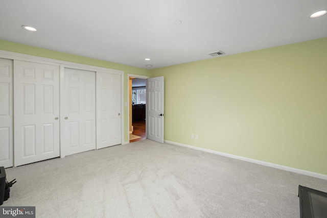 unfurnished bedroom with light carpet