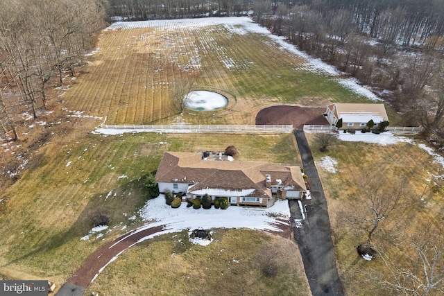 snowy aerial view featuring a rural view