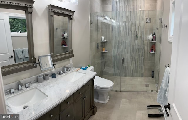 bathroom with vanity, toilet, and a shower with shower door