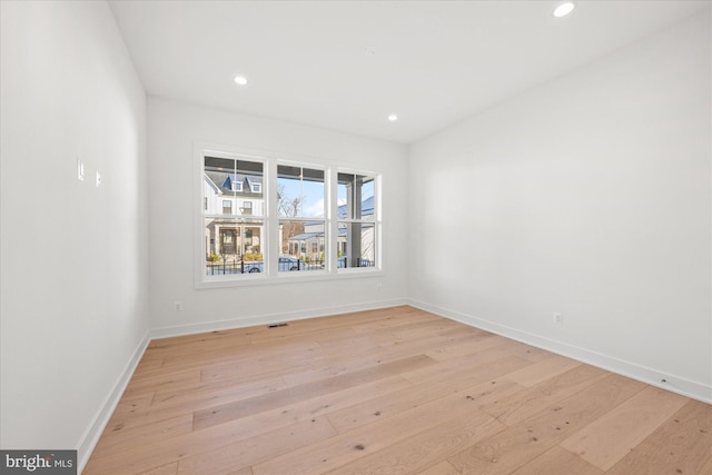 empty room with light hardwood / wood-style floors