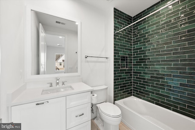 full bathroom with vanity, toilet, and tiled shower / bath