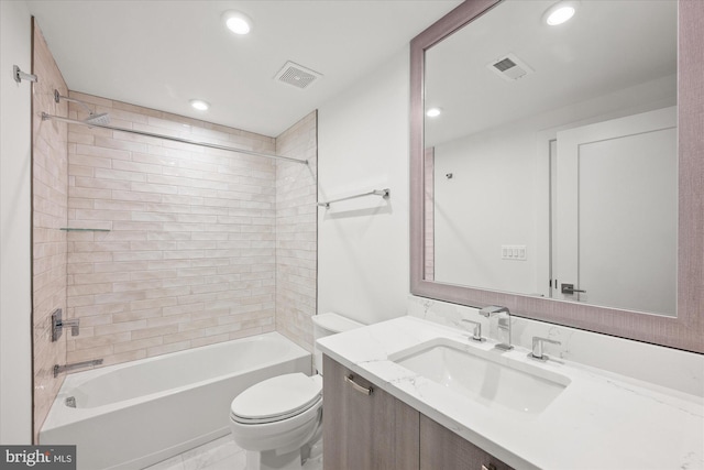 full bathroom featuring vanity, tiled shower / bath combo, and toilet