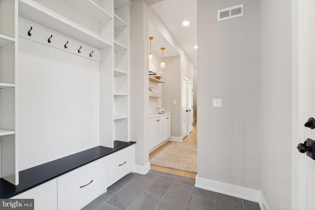 mudroom featuring dark tile patterned flooring