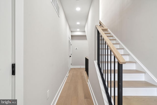 stairway featuring wood-type flooring