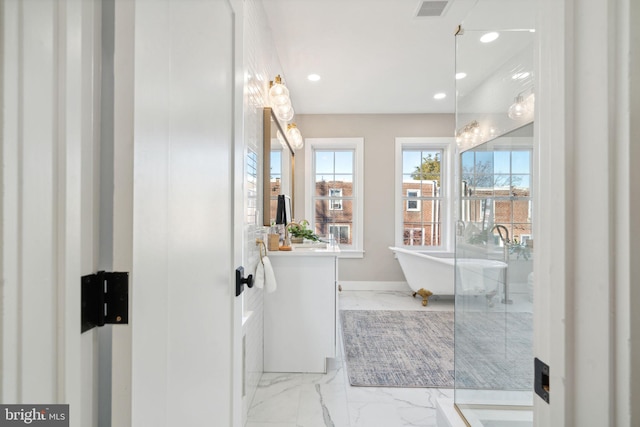 bathroom with a tub to relax in