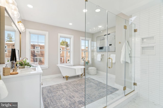 bathroom featuring vanity, a wealth of natural light, and plus walk in shower