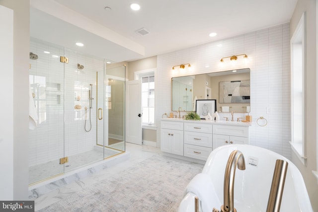 bathroom with vanity, tile walls, and walk in shower