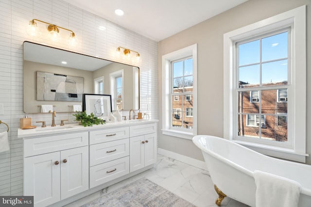 bathroom featuring a tub to relax in and vanity