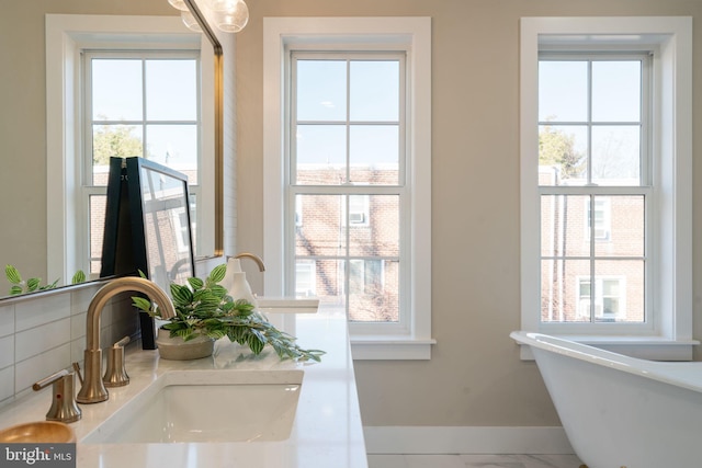 doorway to outside featuring sink and a healthy amount of sunlight