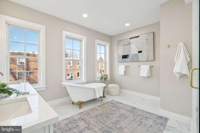 bathroom with a bath and vanity