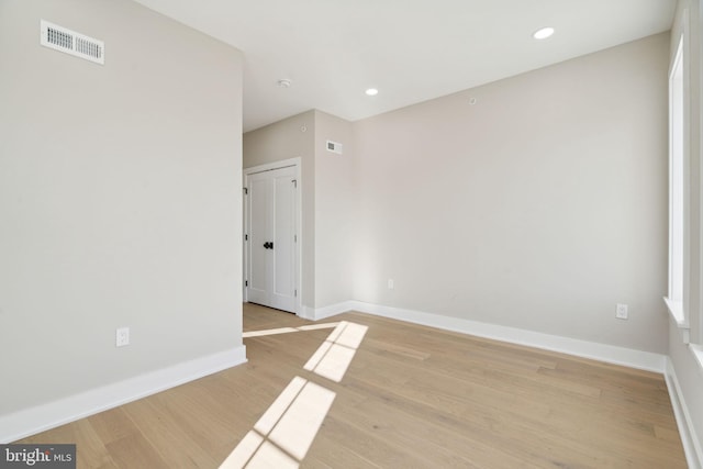 spare room featuring light hardwood / wood-style floors