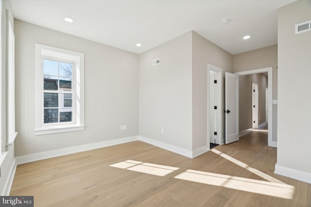 unfurnished room with light wood-type flooring