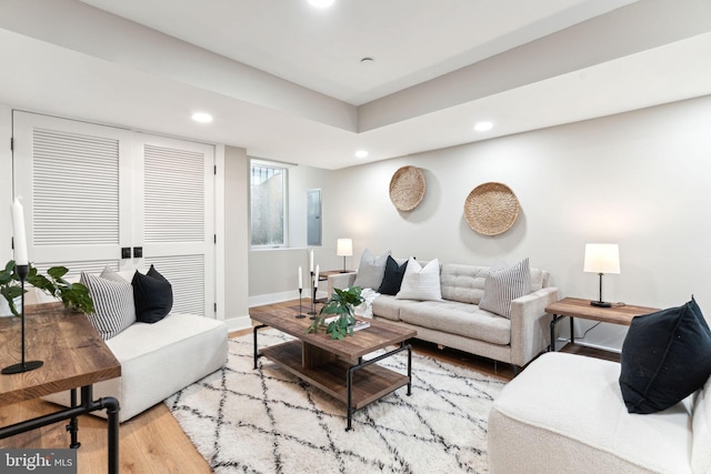 living room featuring electric panel and light hardwood / wood-style flooring