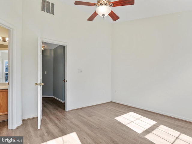 interior space with light wood-style floors, visible vents, and baseboards