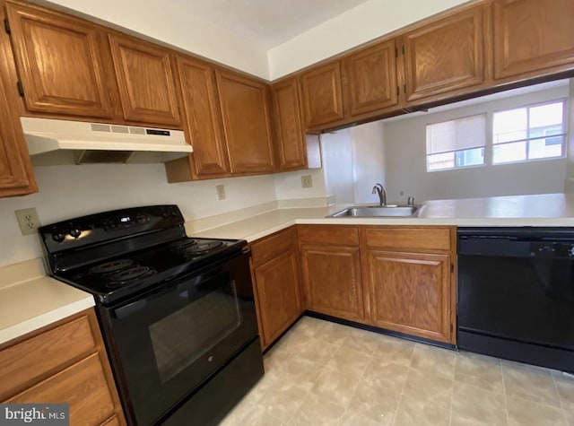 kitchen featuring kitchen peninsula, sink, and black appliances