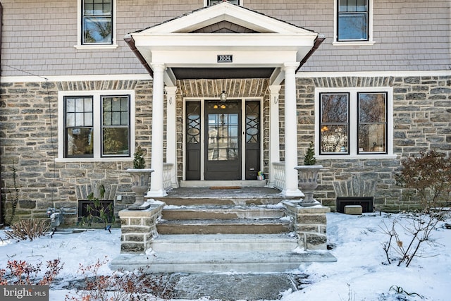 view of snow covered property entrance