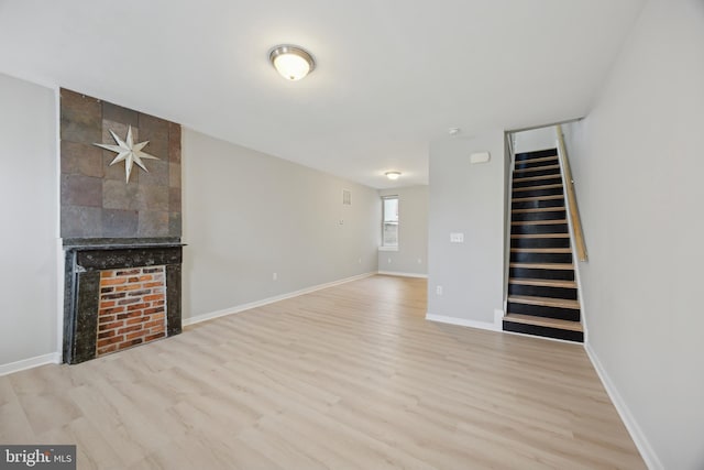 unfurnished living room featuring light hardwood / wood-style flooring and a fireplace