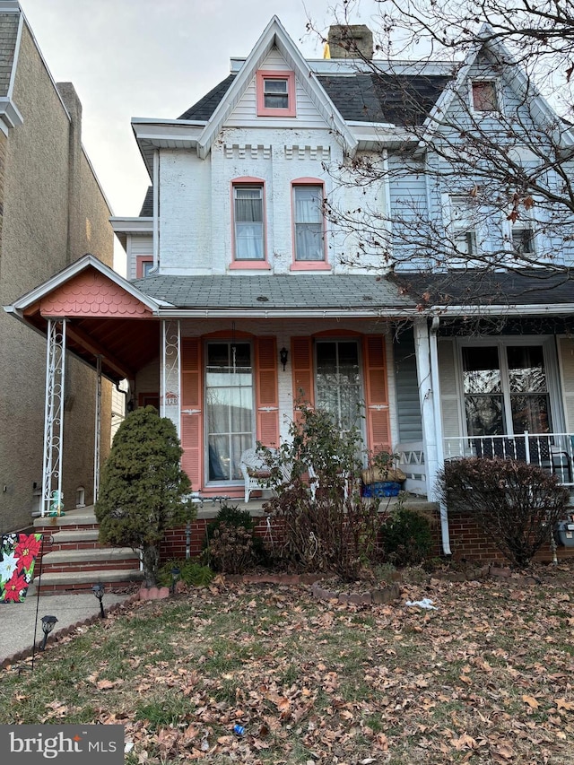 victorian-style house featuring a porch