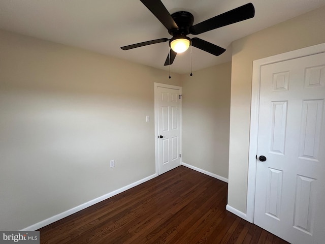 unfurnished bedroom with ceiling fan and dark hardwood / wood-style flooring