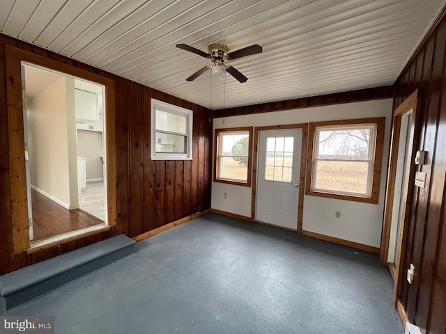 unfurnished sunroom with ceiling fan