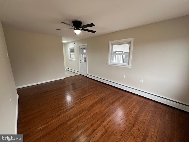 unfurnished room with dark wood-type flooring, baseboard heating, and ceiling fan