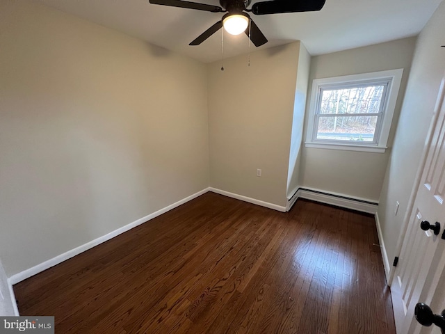 empty room with ceiling fan, dark wood-type flooring, and a baseboard heating unit