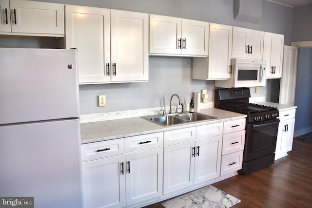 kitchen featuring light stone countertops, sink, white cabinets, and white appliances