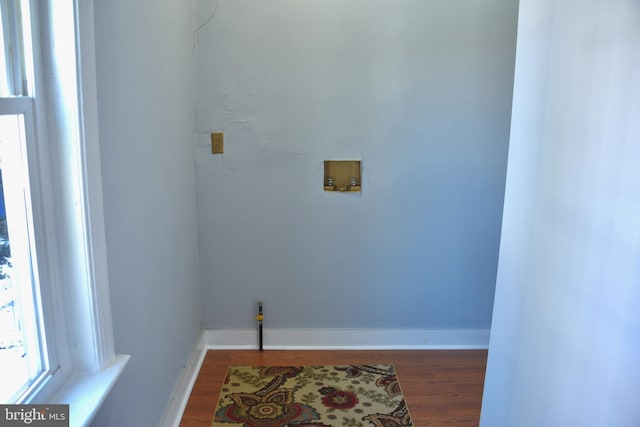 laundry room with washer hookup and hardwood / wood-style flooring