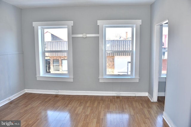 spare room featuring wood-type flooring