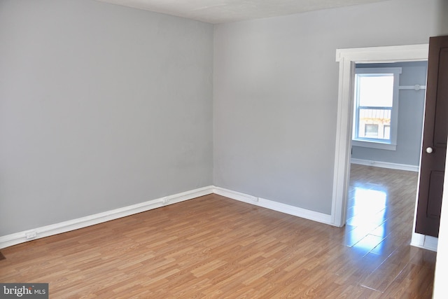 empty room with light hardwood / wood-style flooring