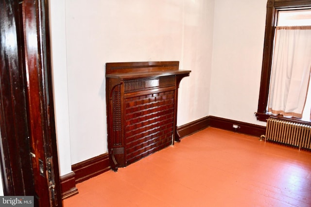 unfurnished bedroom featuring radiator