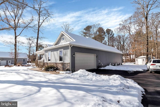 snow covered property featuring a shed