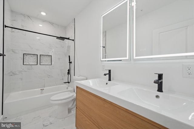 full bathroom with vanity, tiled shower / bath combo, and toilet