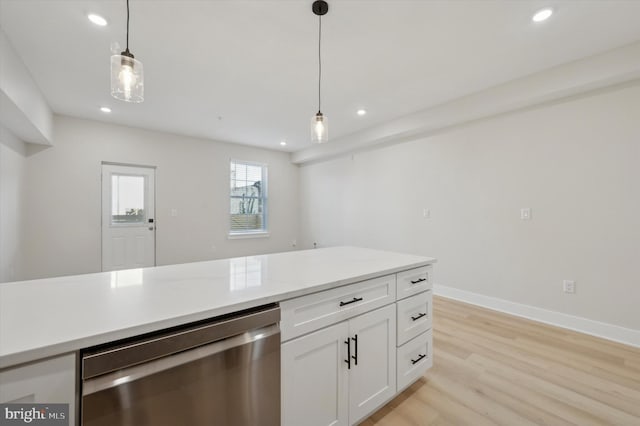 kitchen featuring light stone countertops, hanging light fixtures, stainless steel dishwasher, white cabinets, and light wood-type flooring