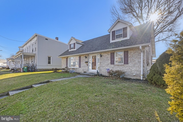 cape cod house with a front lawn