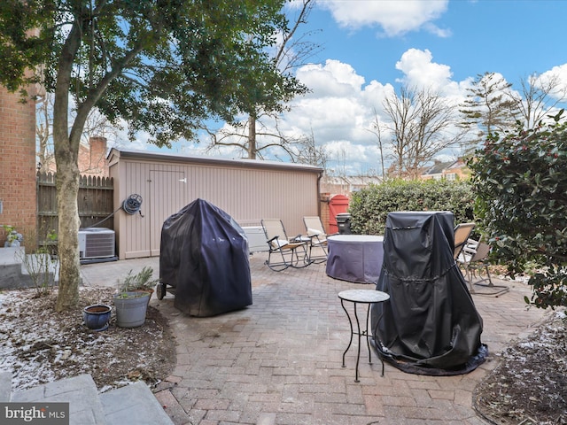 view of patio / terrace with central air condition unit and a grill