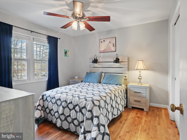 bedroom with ceiling fan and light hardwood / wood-style floors