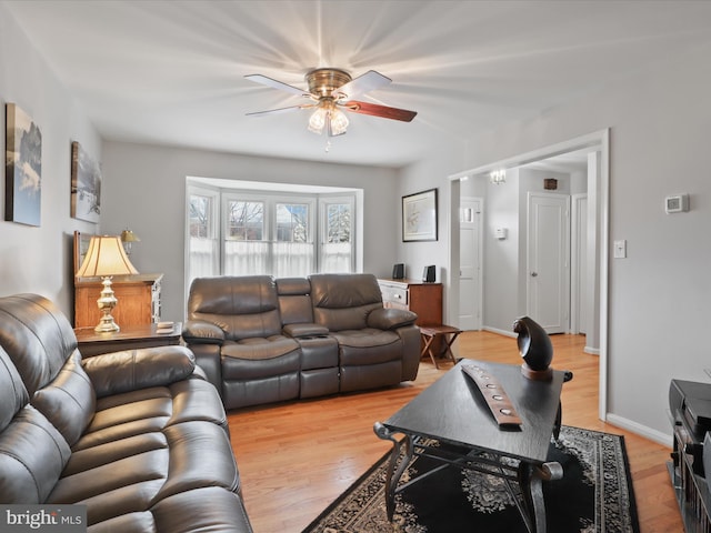 living room featuring ceiling fan and light hardwood / wood-style floors