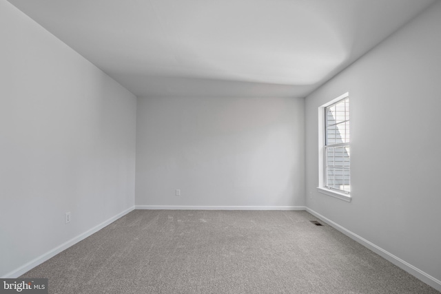 unfurnished room featuring carpet