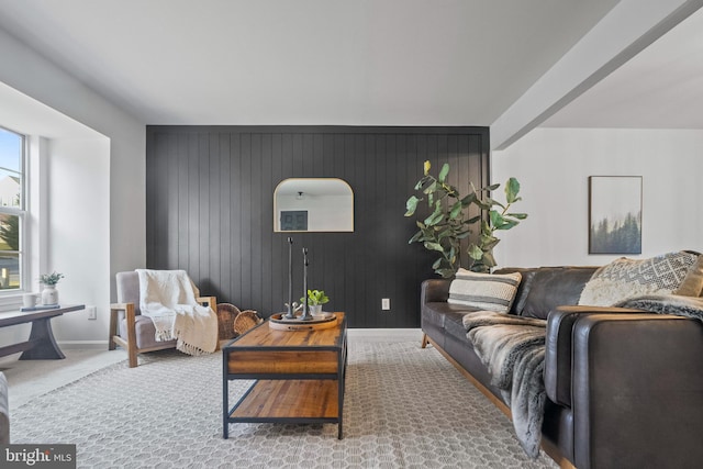 living room featuring wood walls and carpet