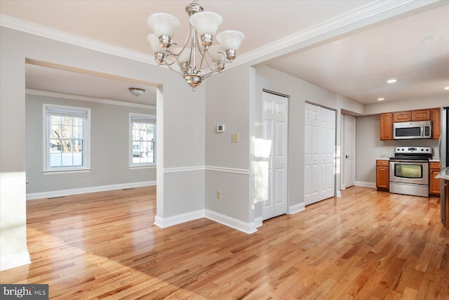 unfurnished dining area featuring light wood-type flooring, crown molding, and a chandelier