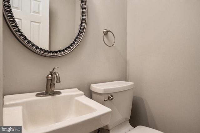 bathroom featuring toilet and sink