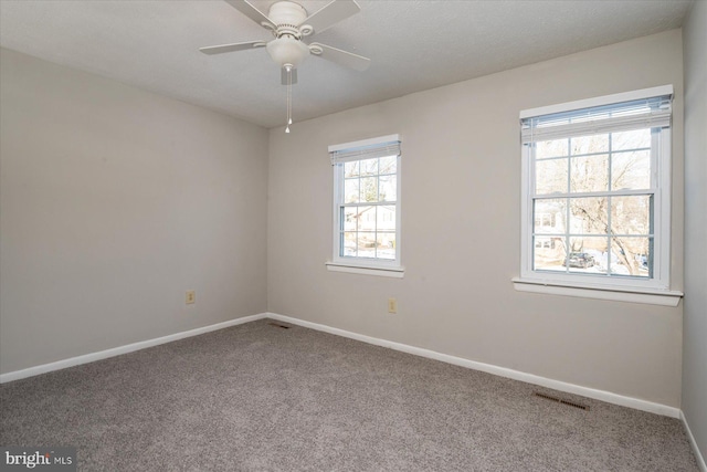 carpeted spare room featuring ceiling fan