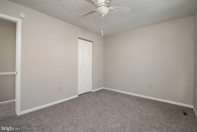 unfurnished bedroom featuring ceiling fan, a closet, carpet, and a textured ceiling