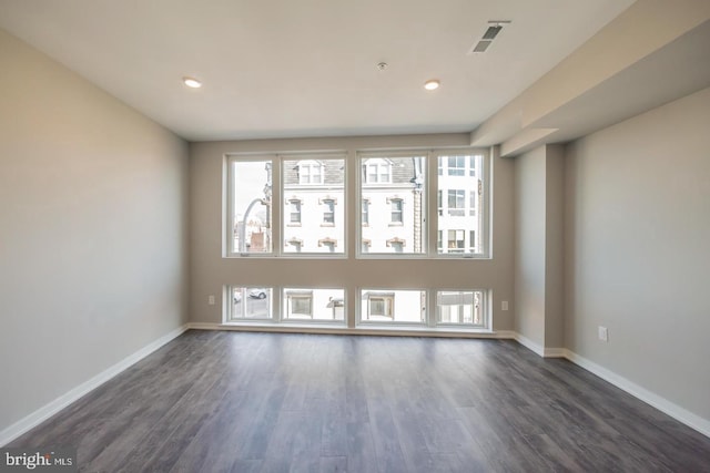 empty room featuring dark hardwood / wood-style flooring